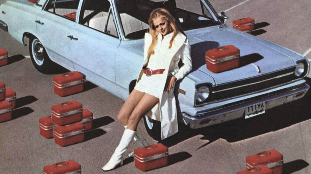 Iranian women leaning on a Paykan car, surrounded by boxes — edited by Ask An Iranian